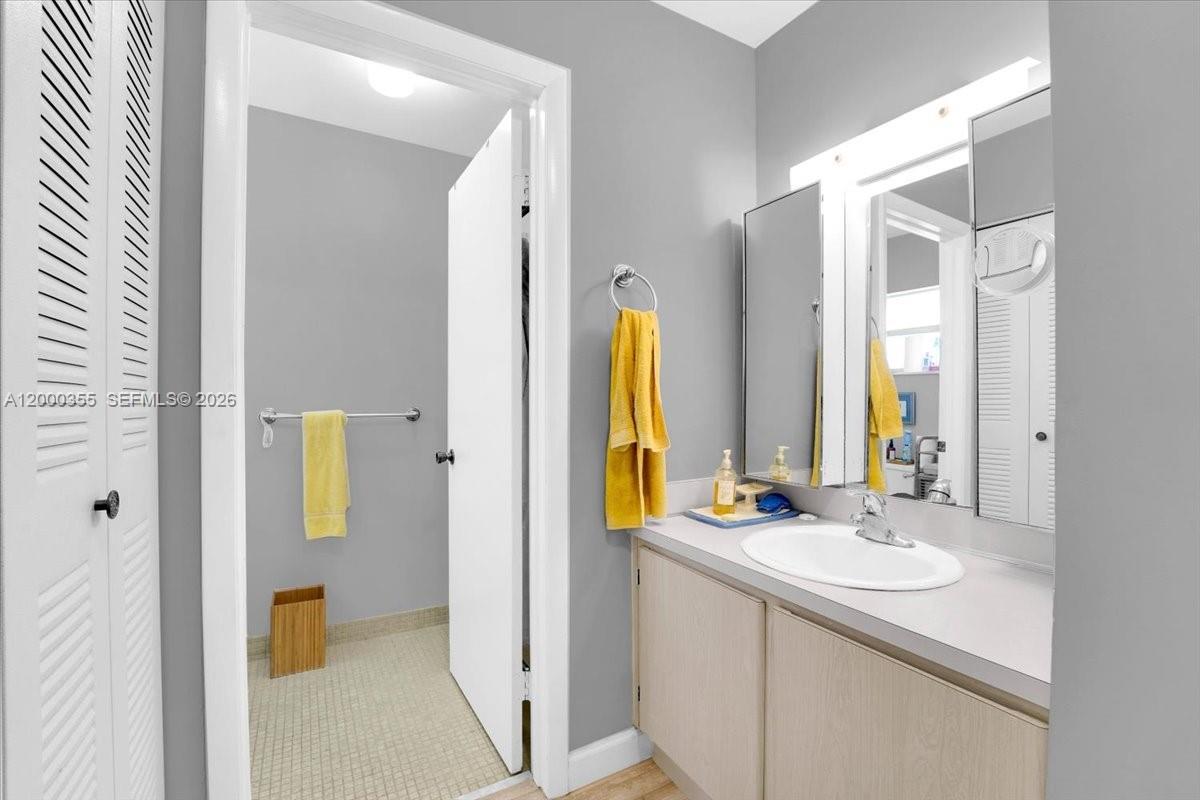 9009 Southwest 138th Street, Unit 202 Miami, FL 33176 - Photo 16 of 23 a bathroom with a sink and a mirror