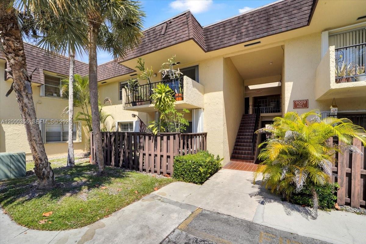 9009 Southwest 138th Street, Unit 202 Miami, FL 33176 - Photo 3 of 23 a view of a house with a small yard and sitting area