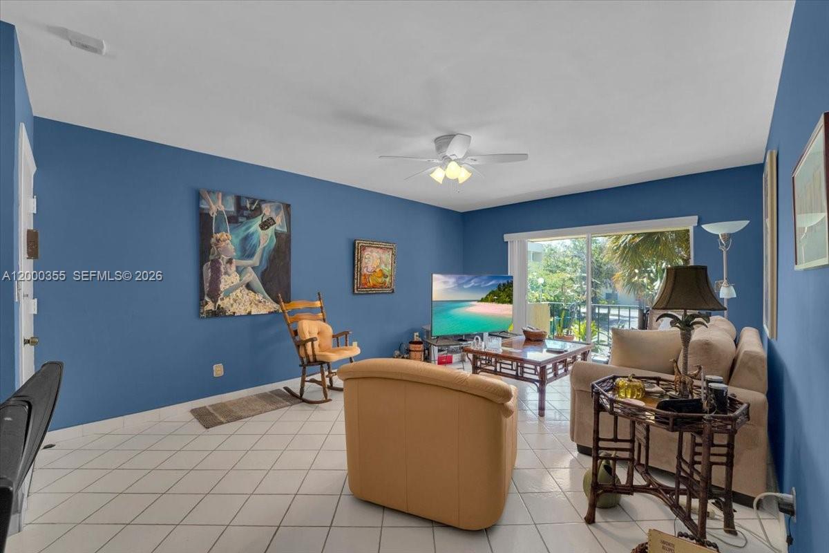 9009 Southwest 138th Street, Unit 202 Miami, FL 33176 - Photo 5 of 23 a living room with furniture a window and a flat screen tv