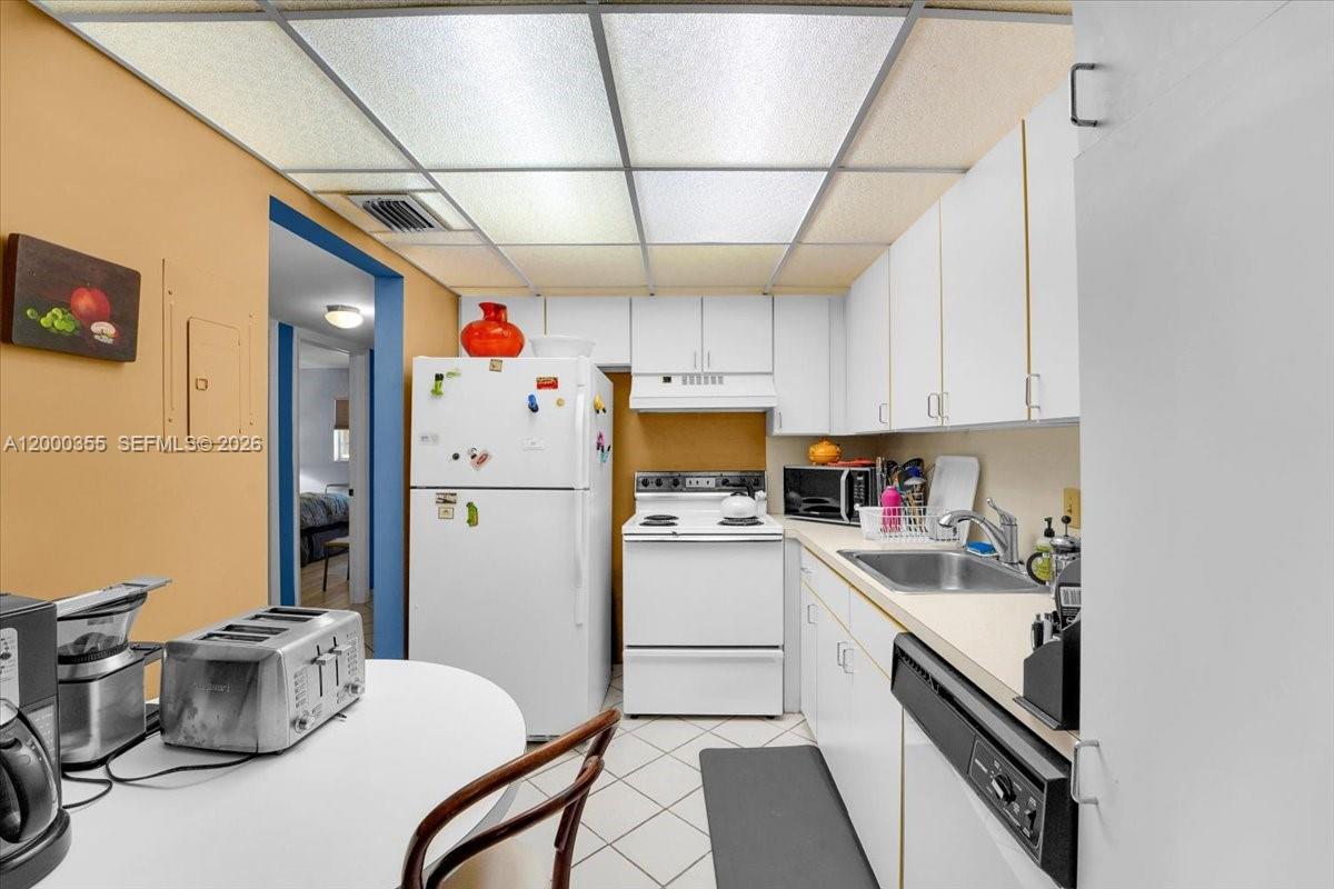 9009 Southwest 138th Street, Unit 202 Miami, FL 33176 - Photo 10 of 23 a kitchen with sink a stove and refrigerator
