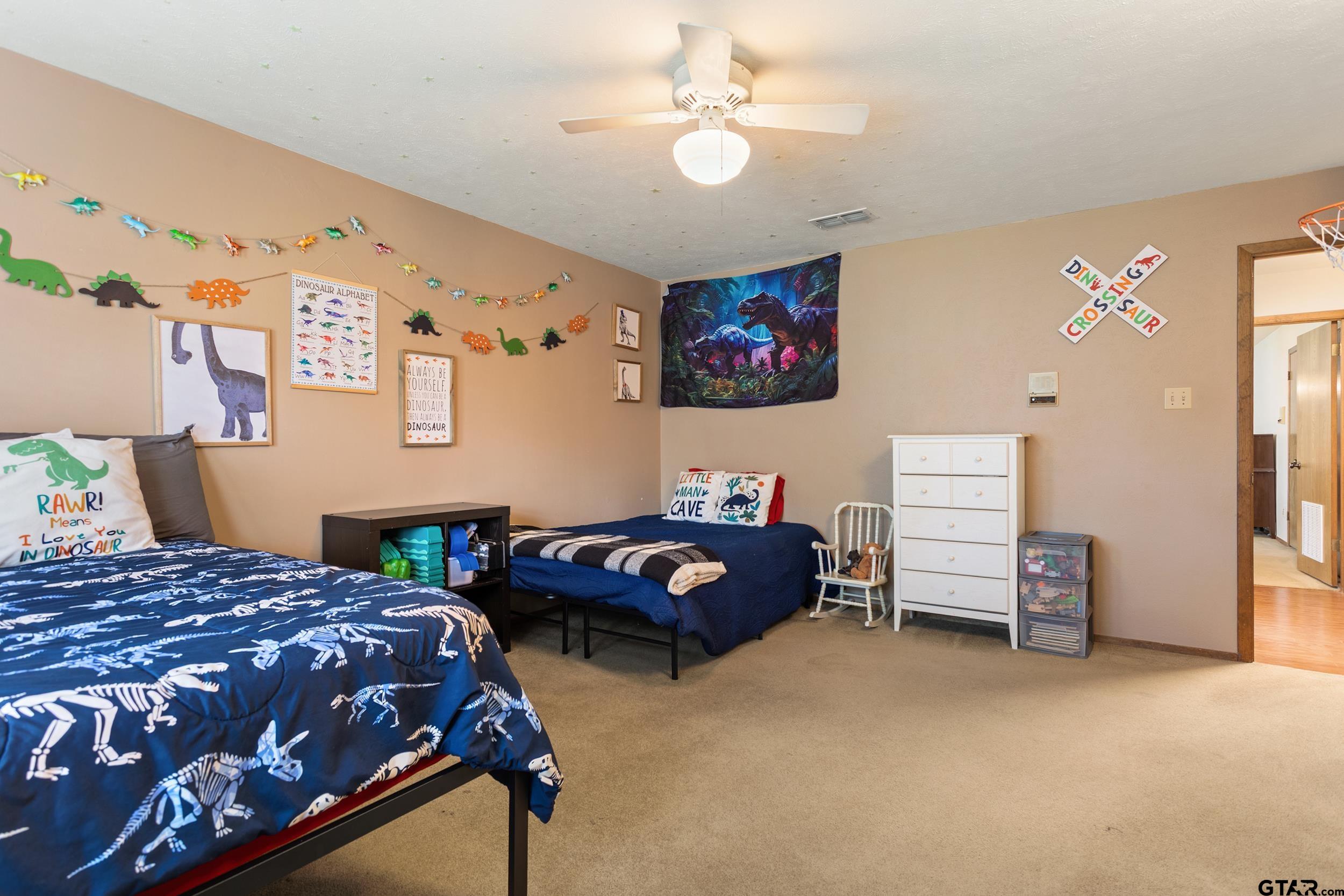 516 Ruthlynn Drive Longview, TX 75605 - Photo 22 of 34 a bedroom with a bed and a chandelier