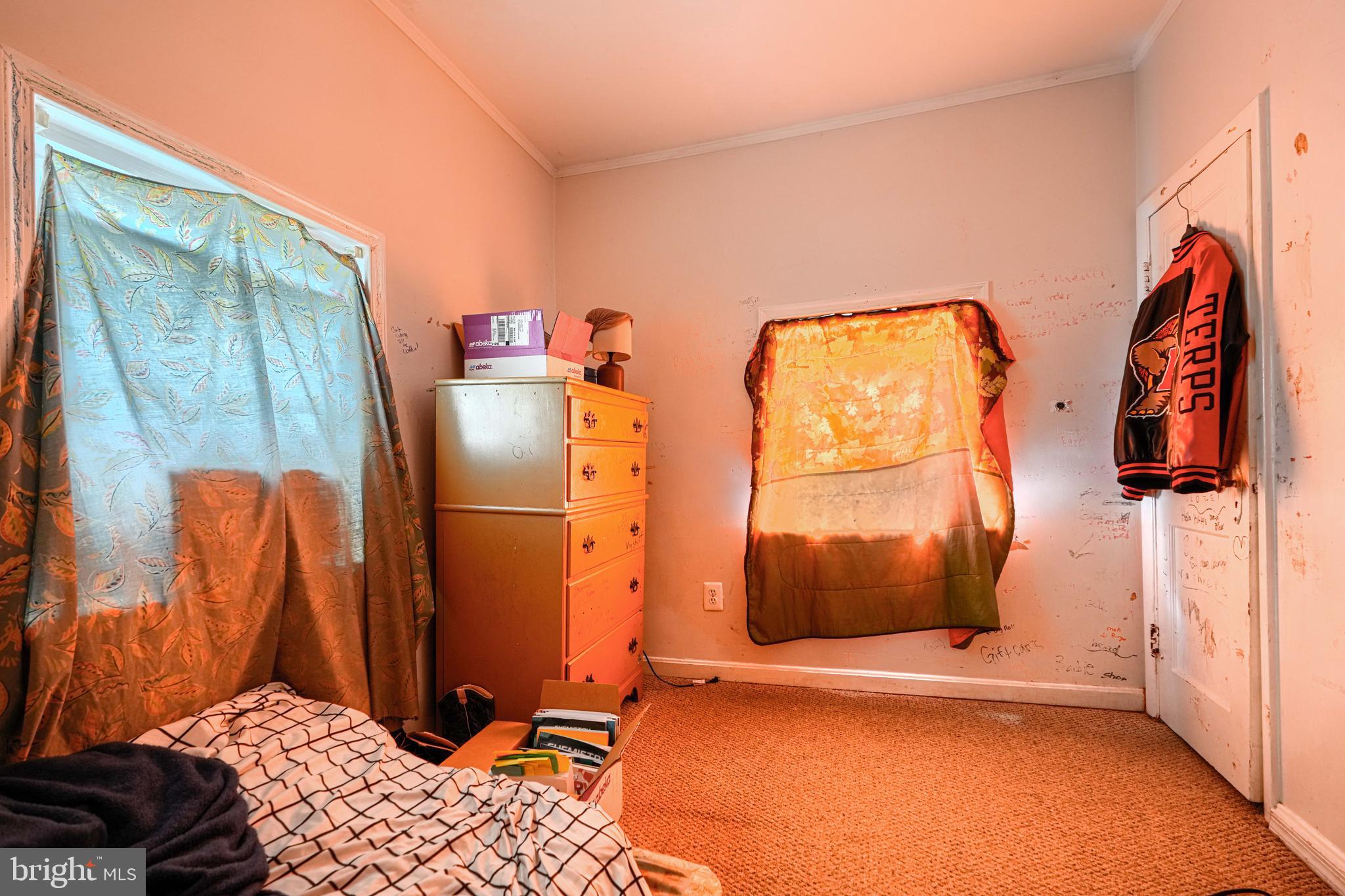 502 Grovethorn Road Middle River, MD 21220 - Photo 13 of 20 a bedroom with a bed and a walk in closet