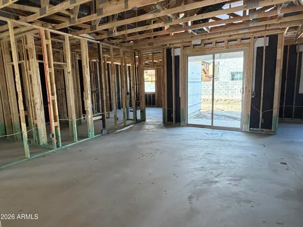 a view of an empty room with glass door and stairs