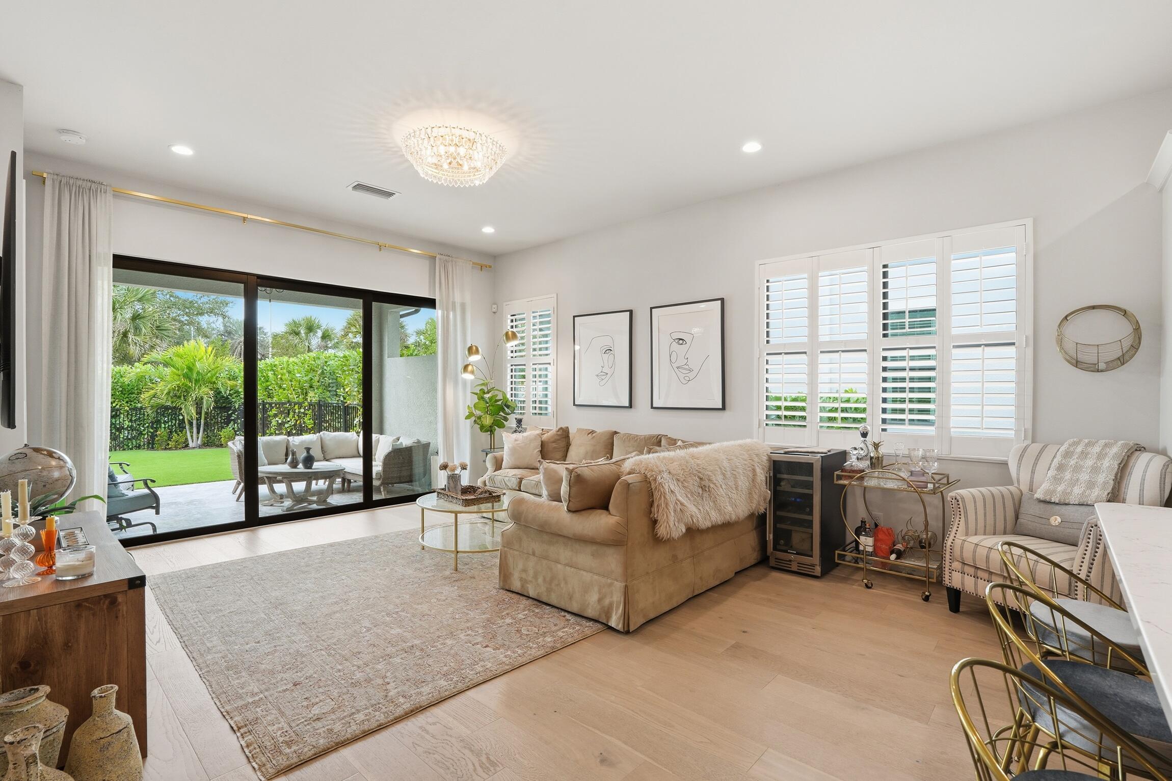 14708 Kingfisher Loop Naples, FL 34120 - Photo 6 of 42 a living room with furniture and large windows