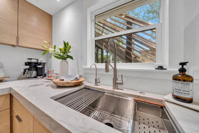 a kitchen with a sink and a stove top oven