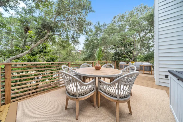 a view of a chairs and table in the balcony
