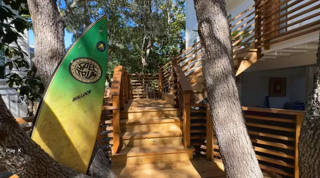 a view of a large trees with wooden fence