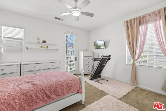 a bedroom with a bed and painting on the wall