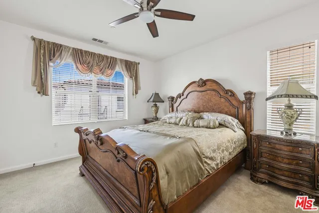 a view of walk in closet with clothes