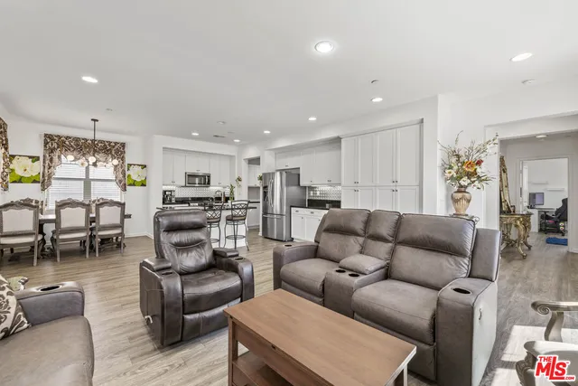 a living room kitchen with furniture and a large window