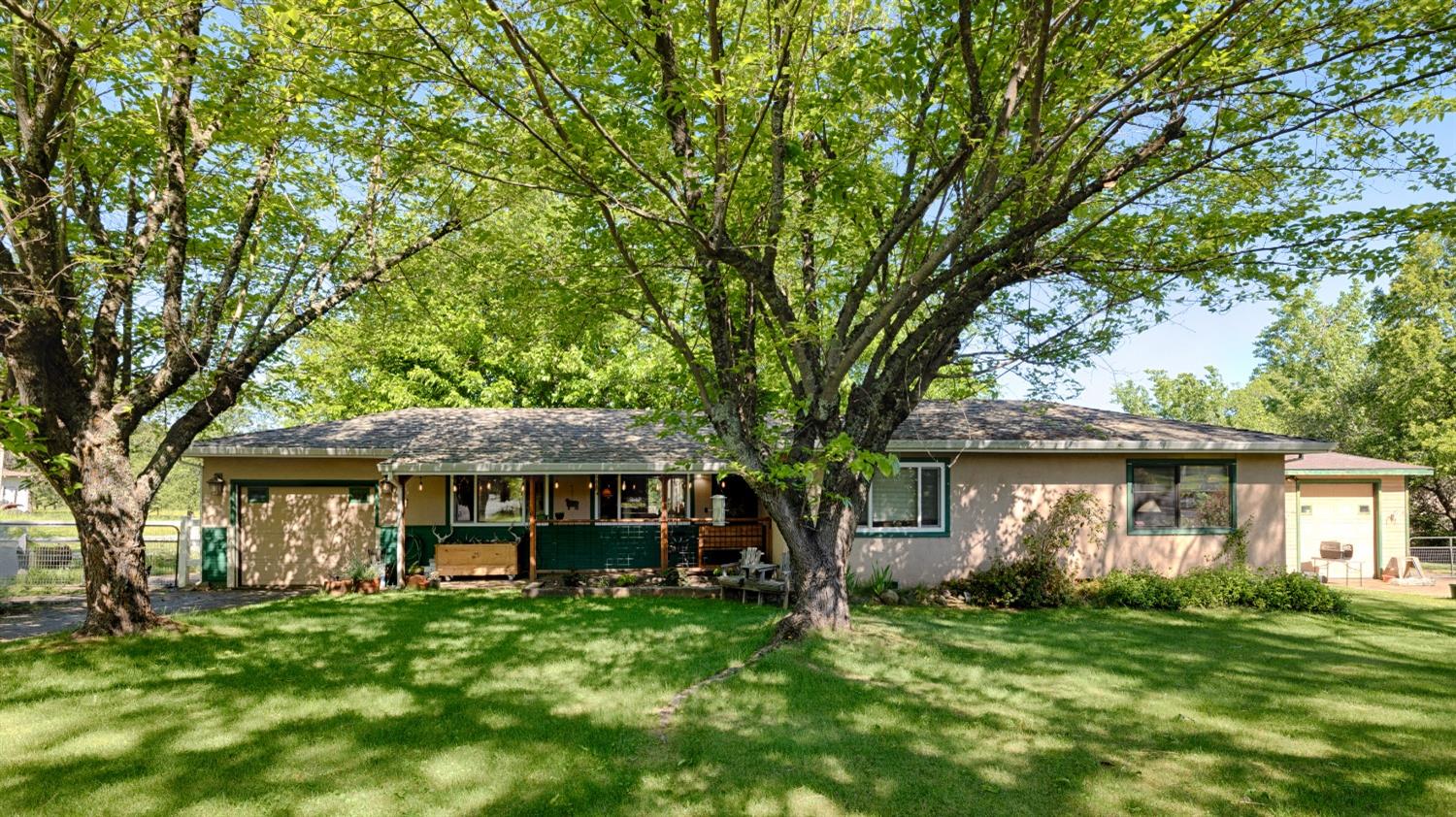 a front view of a house with a garden