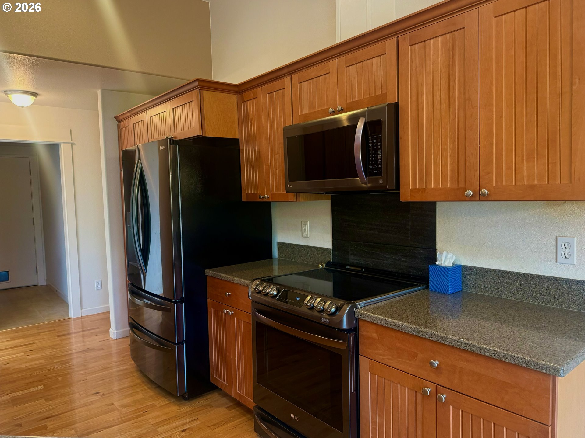 4797 Cloudcroft Lane Florence, OR 97439 - Photo 12 of 33 a kitchen with stainless steel appliances granite countertop a refrigerator stove and microwave