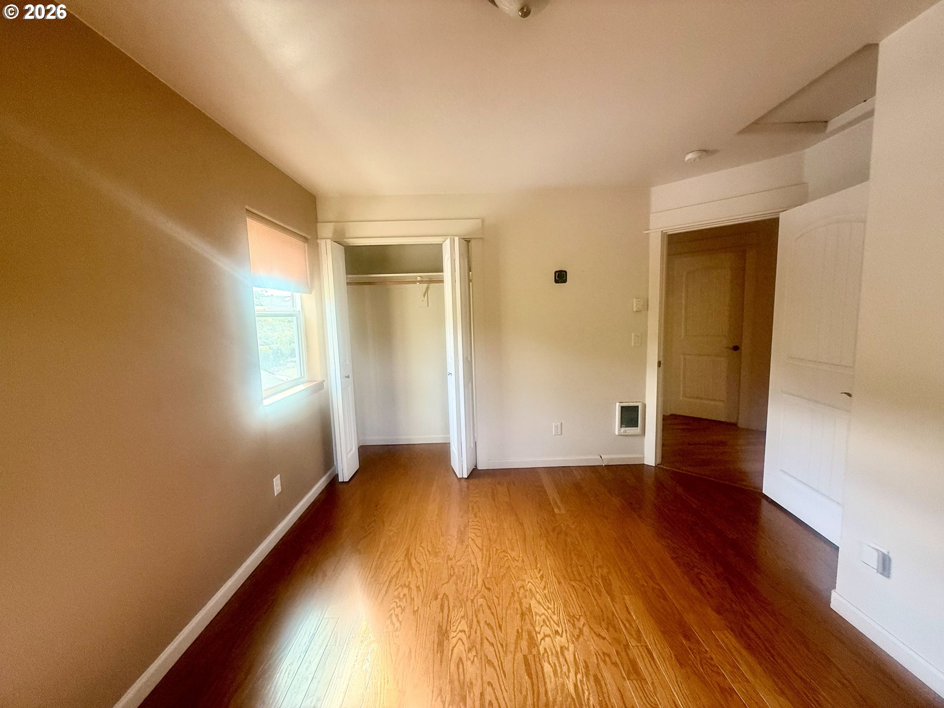 4797 Cloudcroft Lane Florence, OR 97439 - Photo 17 of 33 an empty room with wooden floor and windows