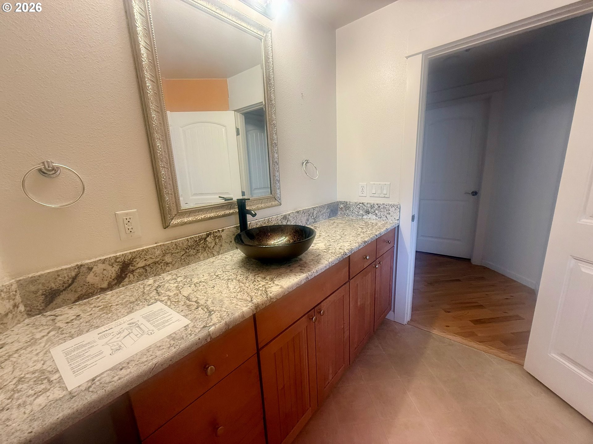 4797 Cloudcroft Lane Florence, OR 97439 - Photo 18 of 33 a bathroom with a granite countertop sink and a mirror
