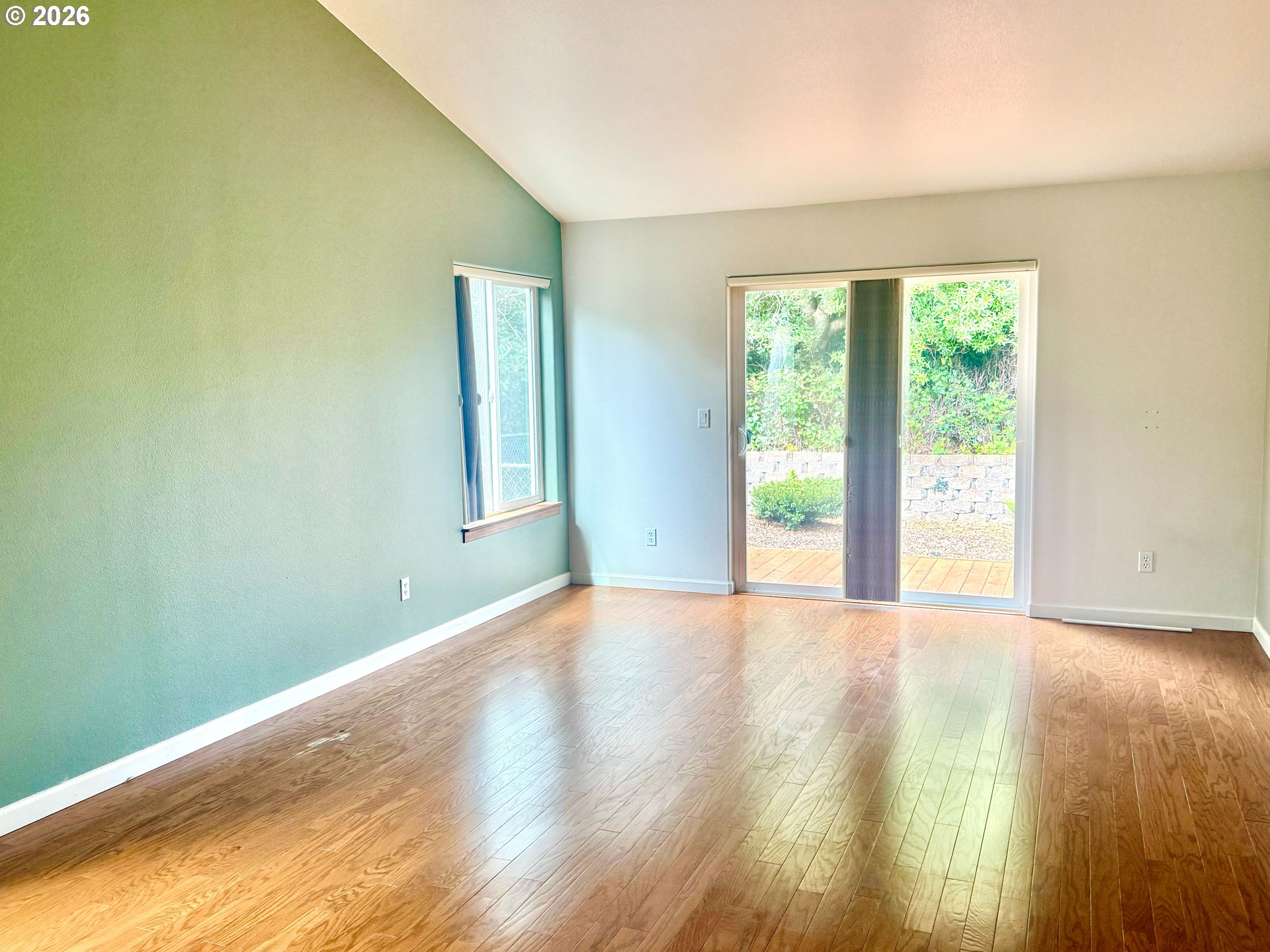 4797 Cloudcroft Lane Florence, OR 97439 - Photo 19 of 33 a view of an empty room with wooden floor and a window