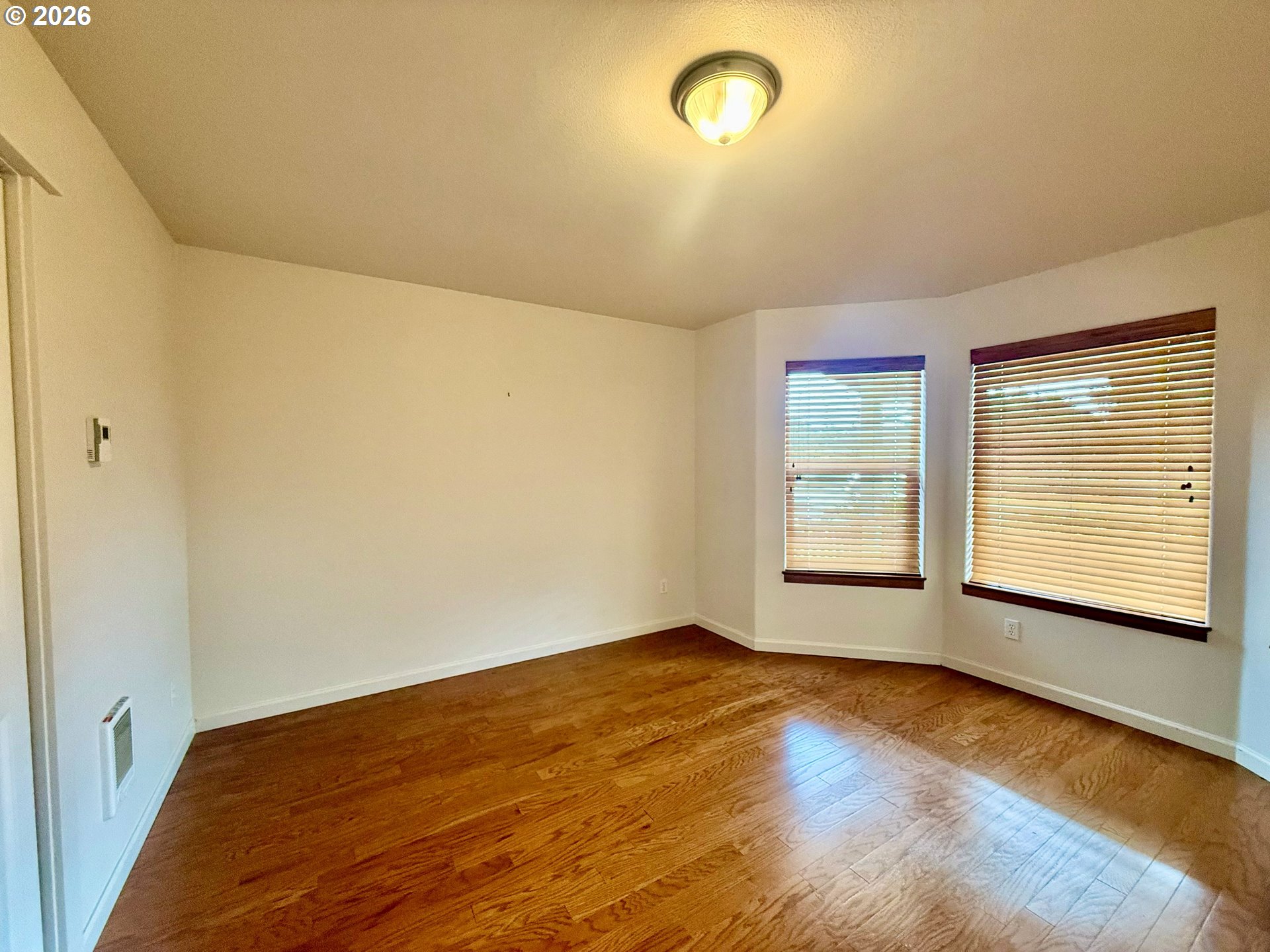 4797 Cloudcroft Lane Florence, OR 97439 - Photo 27 of 33 a view of an empty room with wooden floor and a window