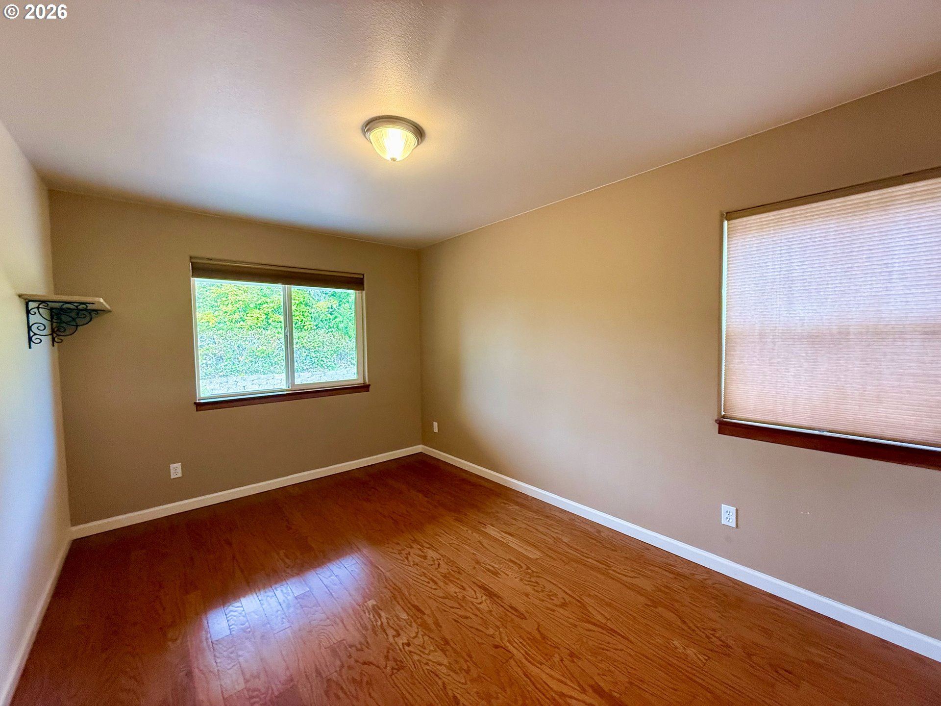 4797 Cloudcroft Lane Florence, OR 97439 - Photo 29 of 33 a view of an empty room with wooden floor and a window