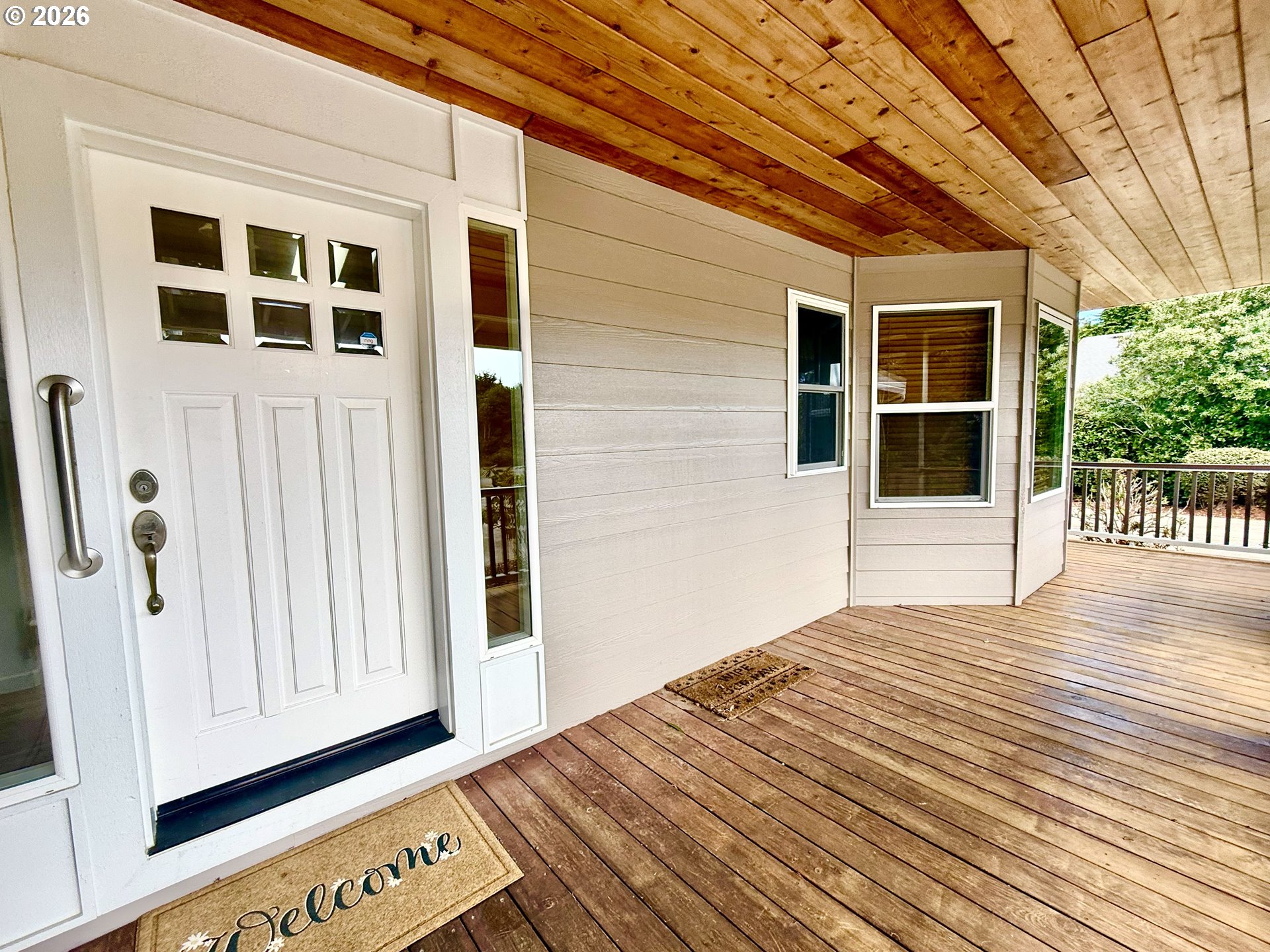 4797 Cloudcroft Lane Florence, OR 97439 - Photo 4 of 33 a view of a porch with wooden floor and fence