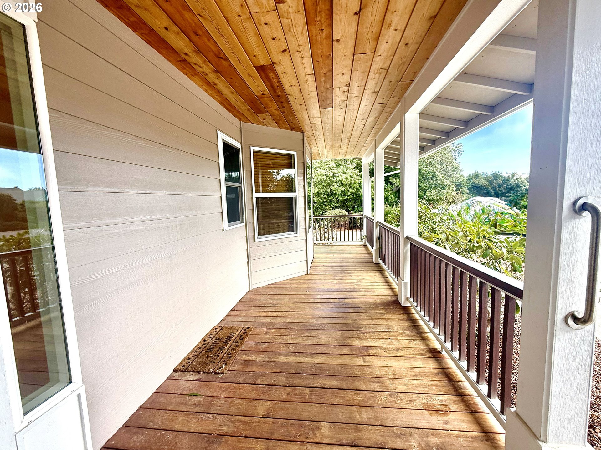 4797 Cloudcroft Lane Florence, OR 97439 - Photo 5 of 33 a porch with wooden floor and fence