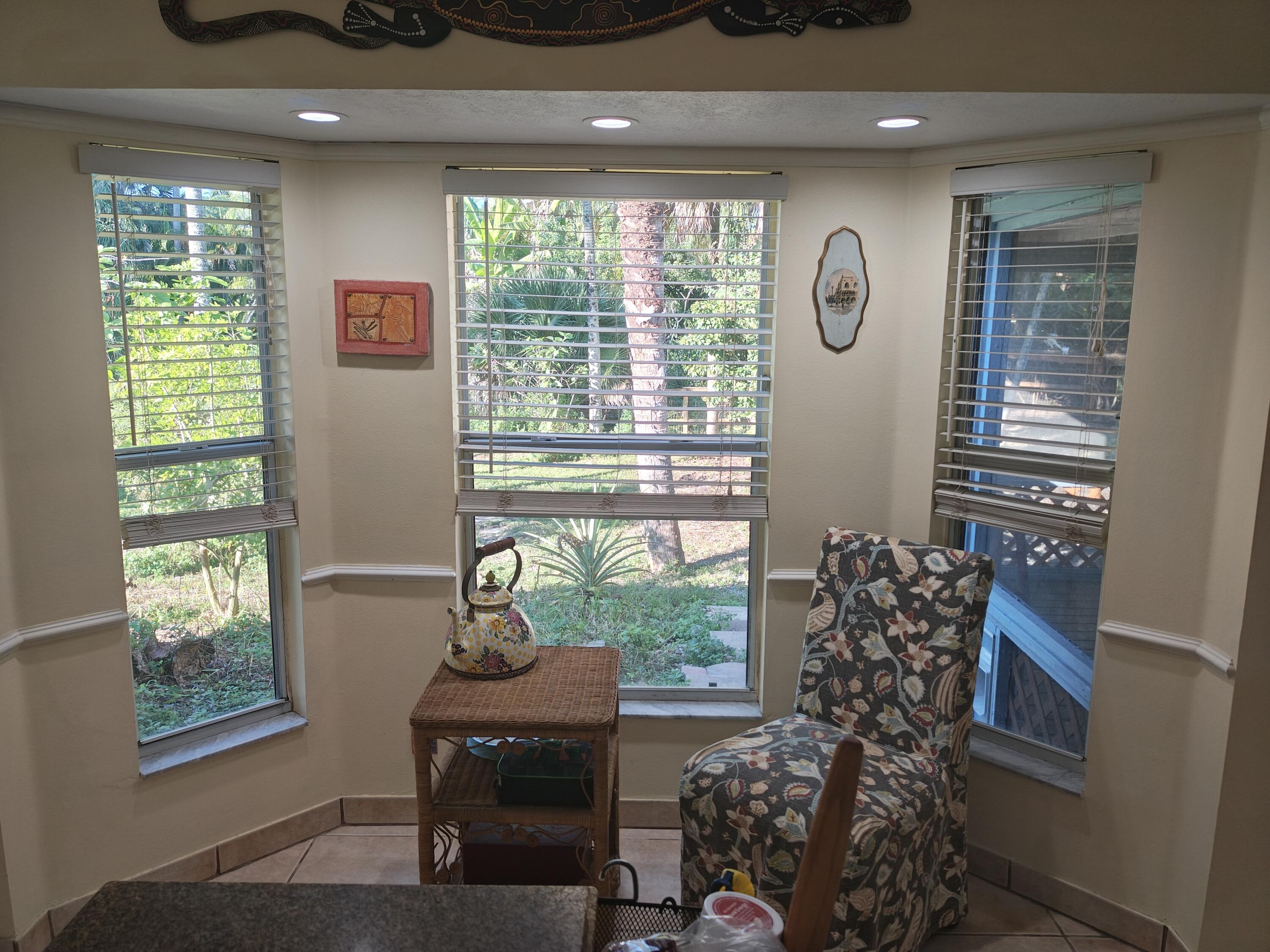 13747 42nd Road North Royal Palm Beach, FL 33411 - Photo 17 of 31 a living room with furniture and a floor to ceiling window