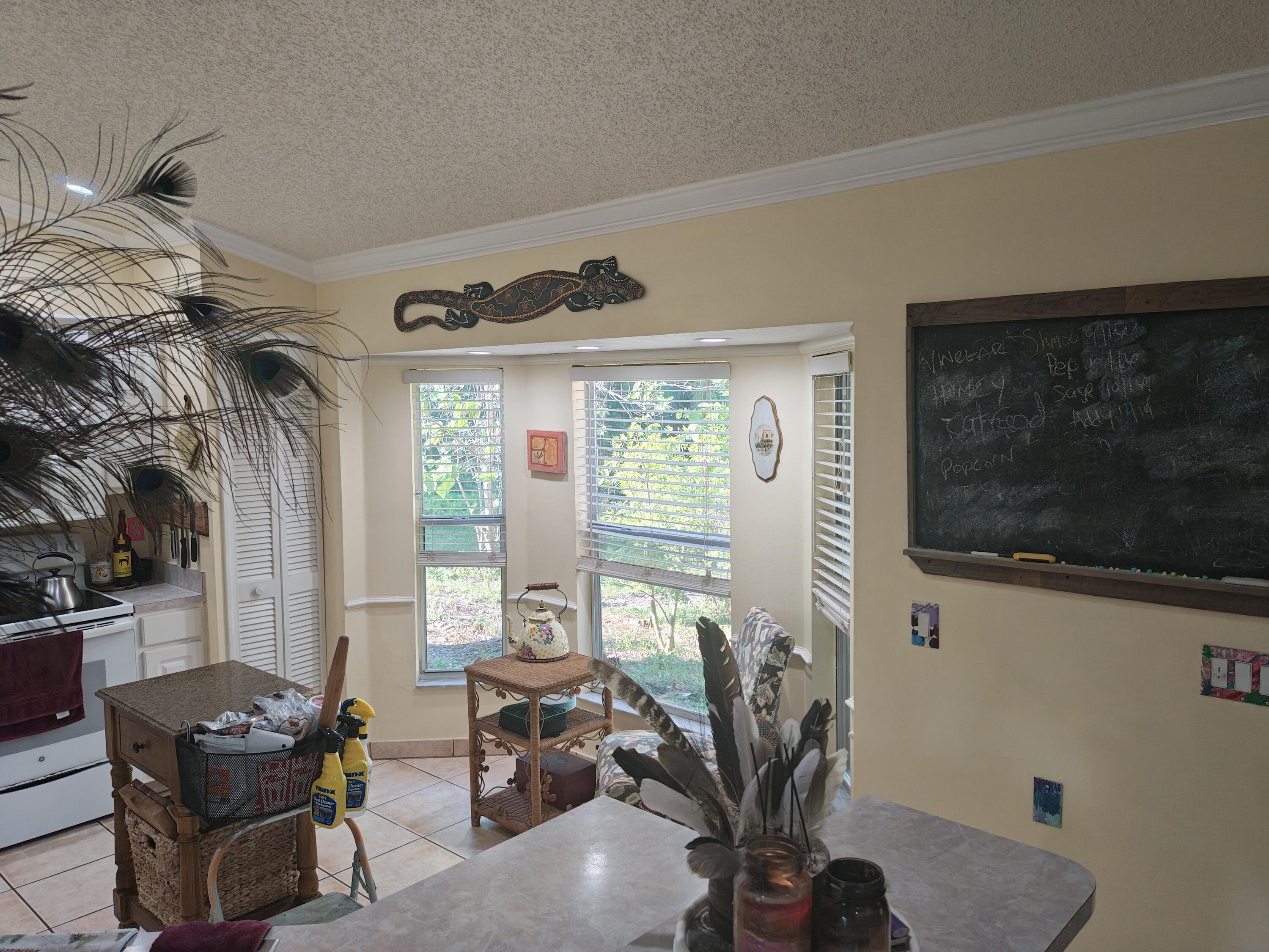 13747 42nd Road North Royal Palm Beach, FL 33411 - Photo 18 of 31 a living room with furniture a flat screen tv and a window