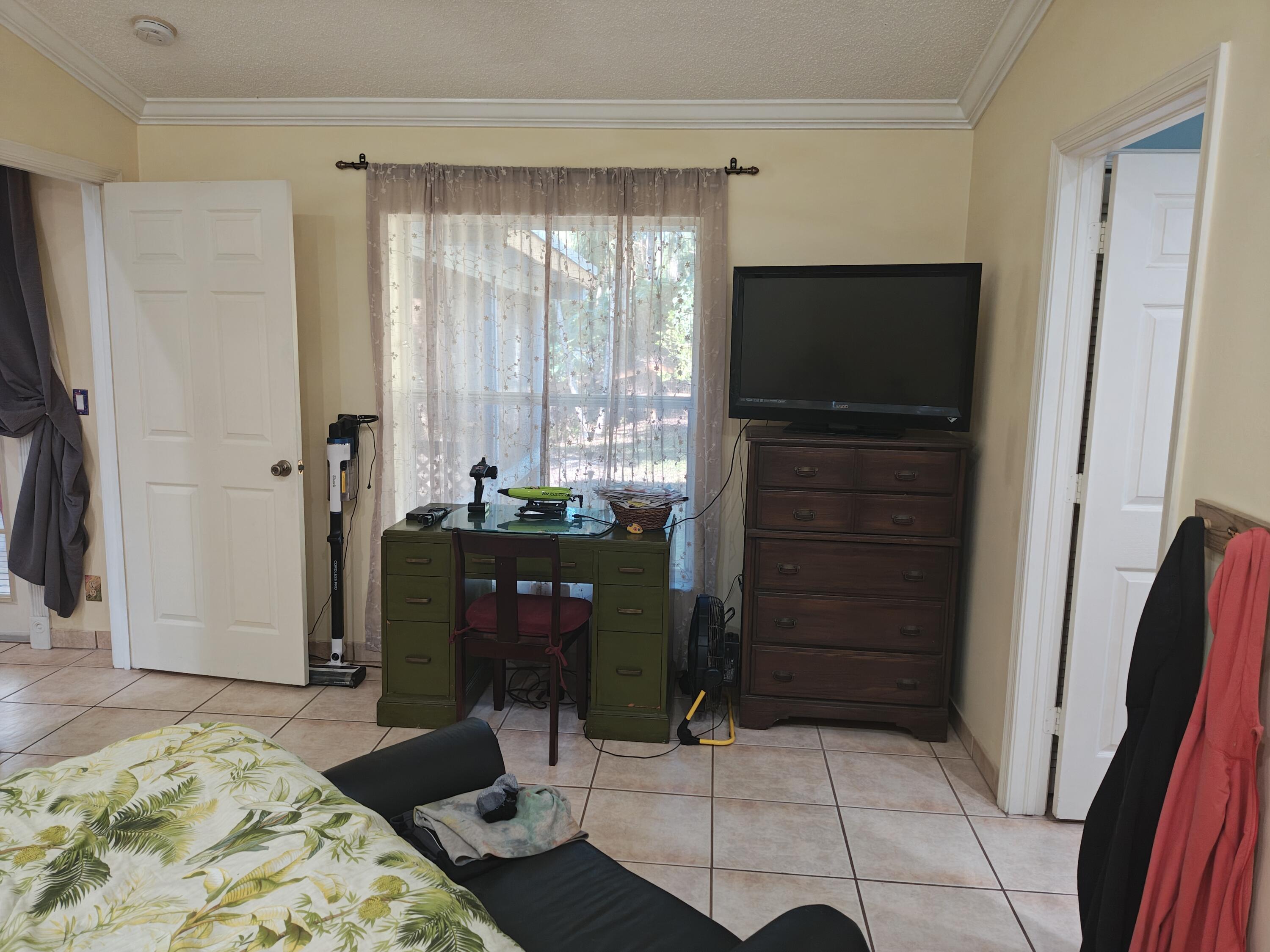 13747 42nd Road North Royal Palm Beach, FL 33411 - Photo 19 of 31 a living room with furniture and a flat screen tv