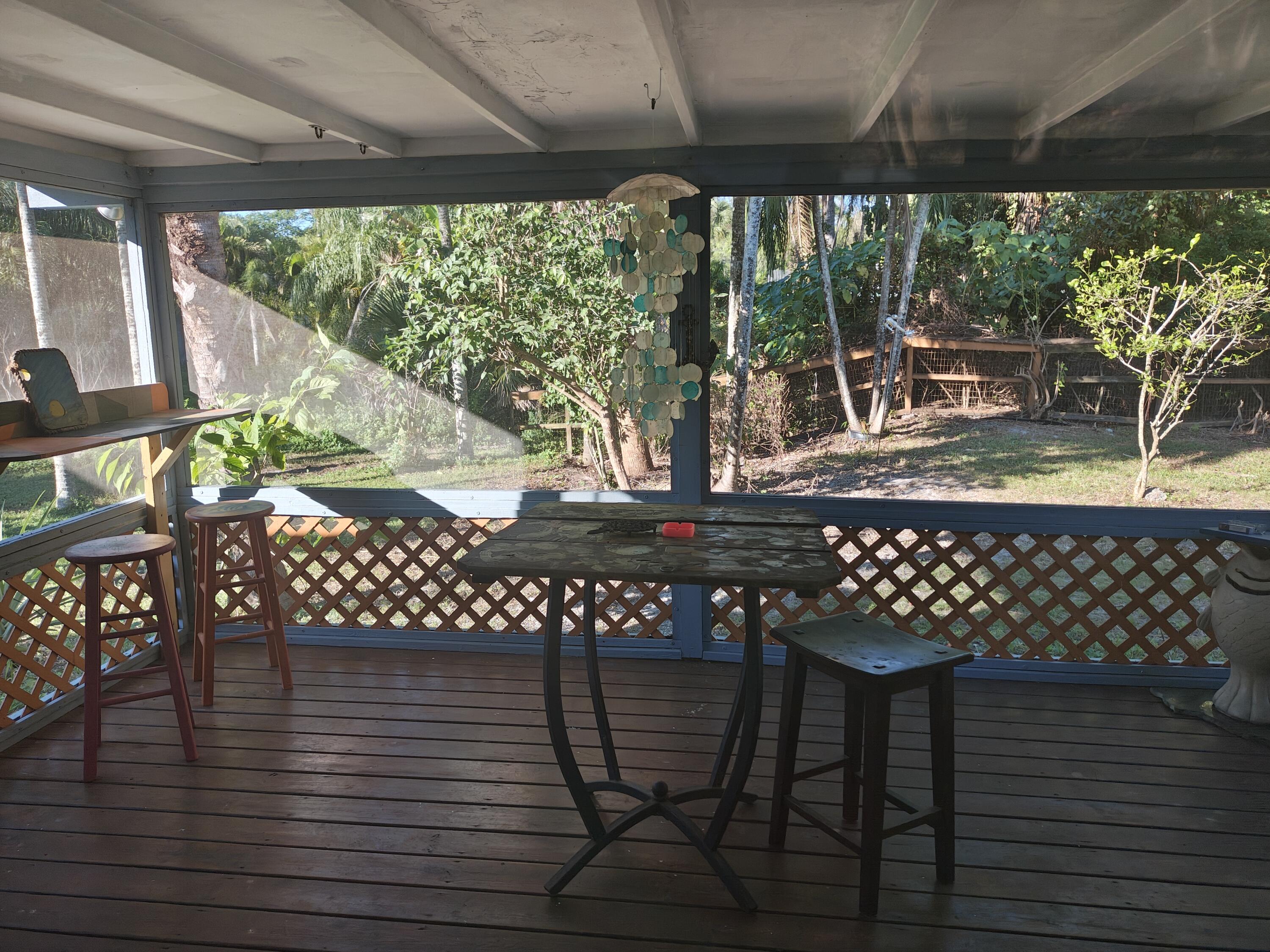13747 42nd Road North Royal Palm Beach, FL 33411 - Photo 20 of 31 a view of a chairs and table in the patio