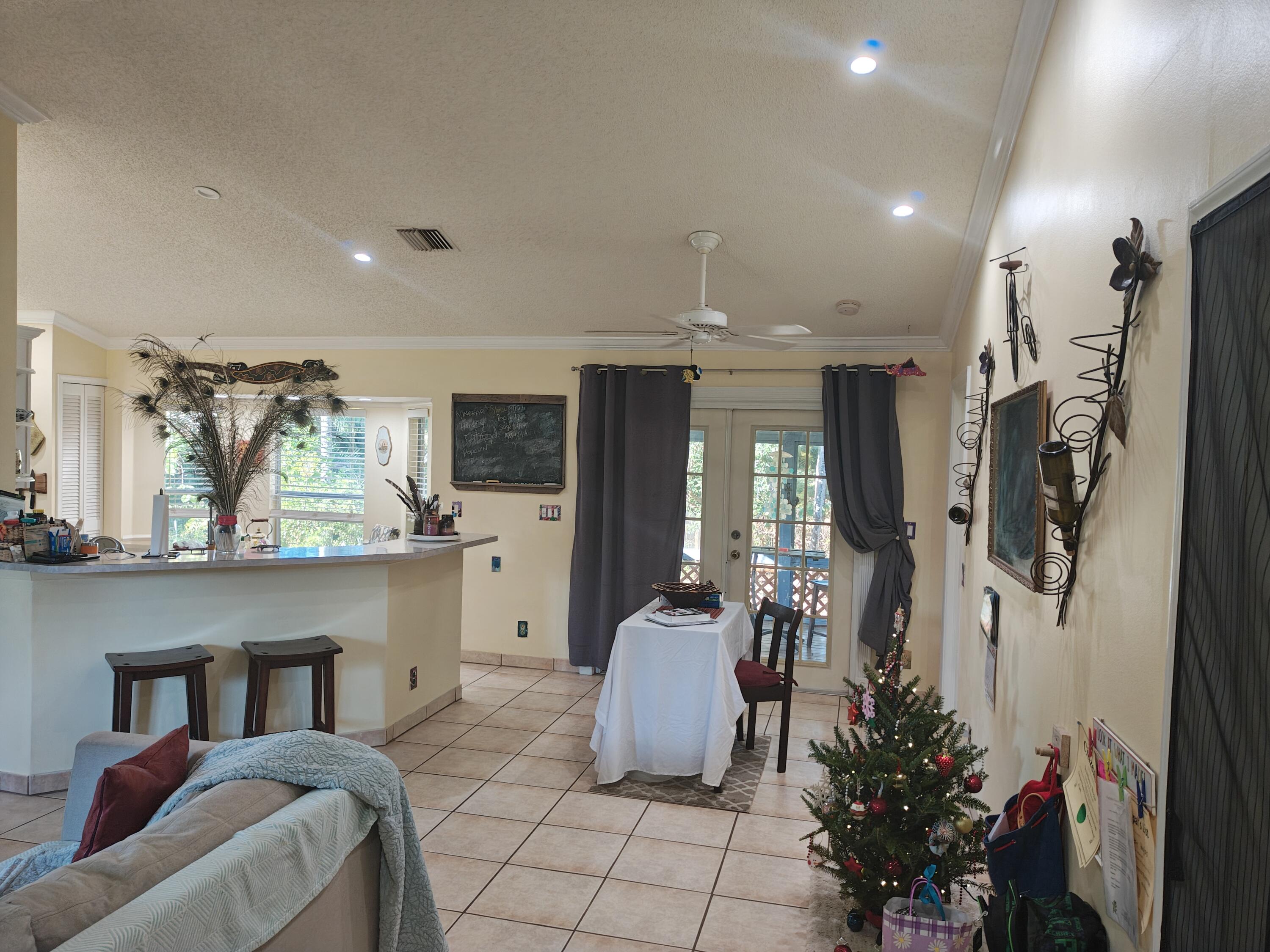 13747 42nd Road North Royal Palm Beach, FL 33411 - Photo 30 of 31 a living room with furniture and flowers