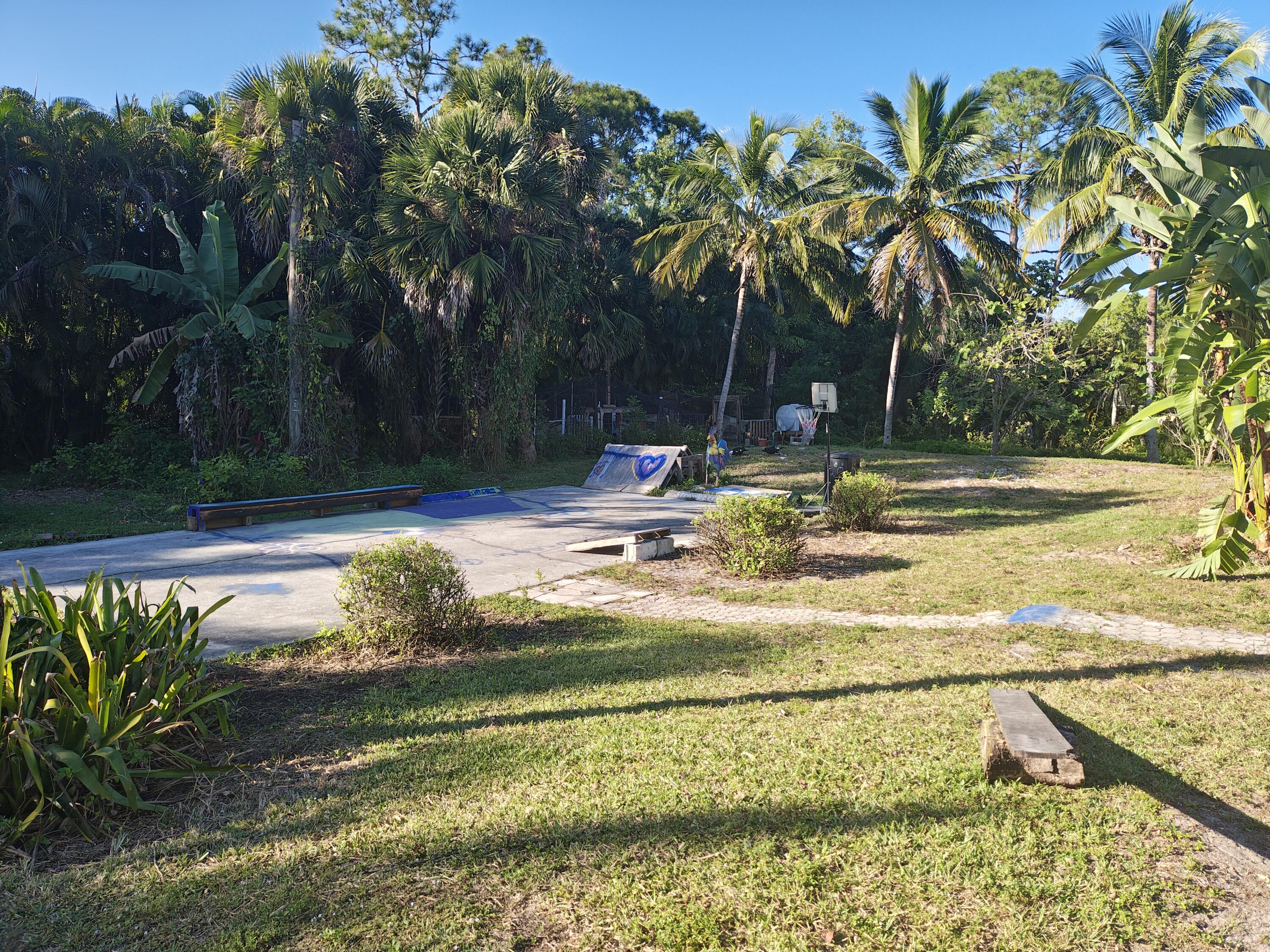 13747 42nd Road North Royal Palm Beach, FL 33411 - Photo 6 of 31 a view of a swimming pool with a patio and a lake view