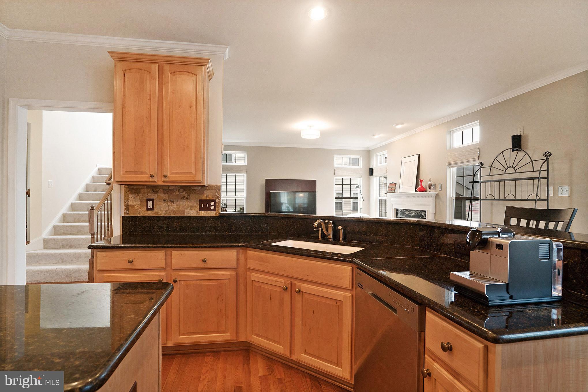 18411 Cornflower Road Boyds, MD 20841 - Photo 11 of 28 a kitchen with stainless steel appliances granite countertop a sink and a stove