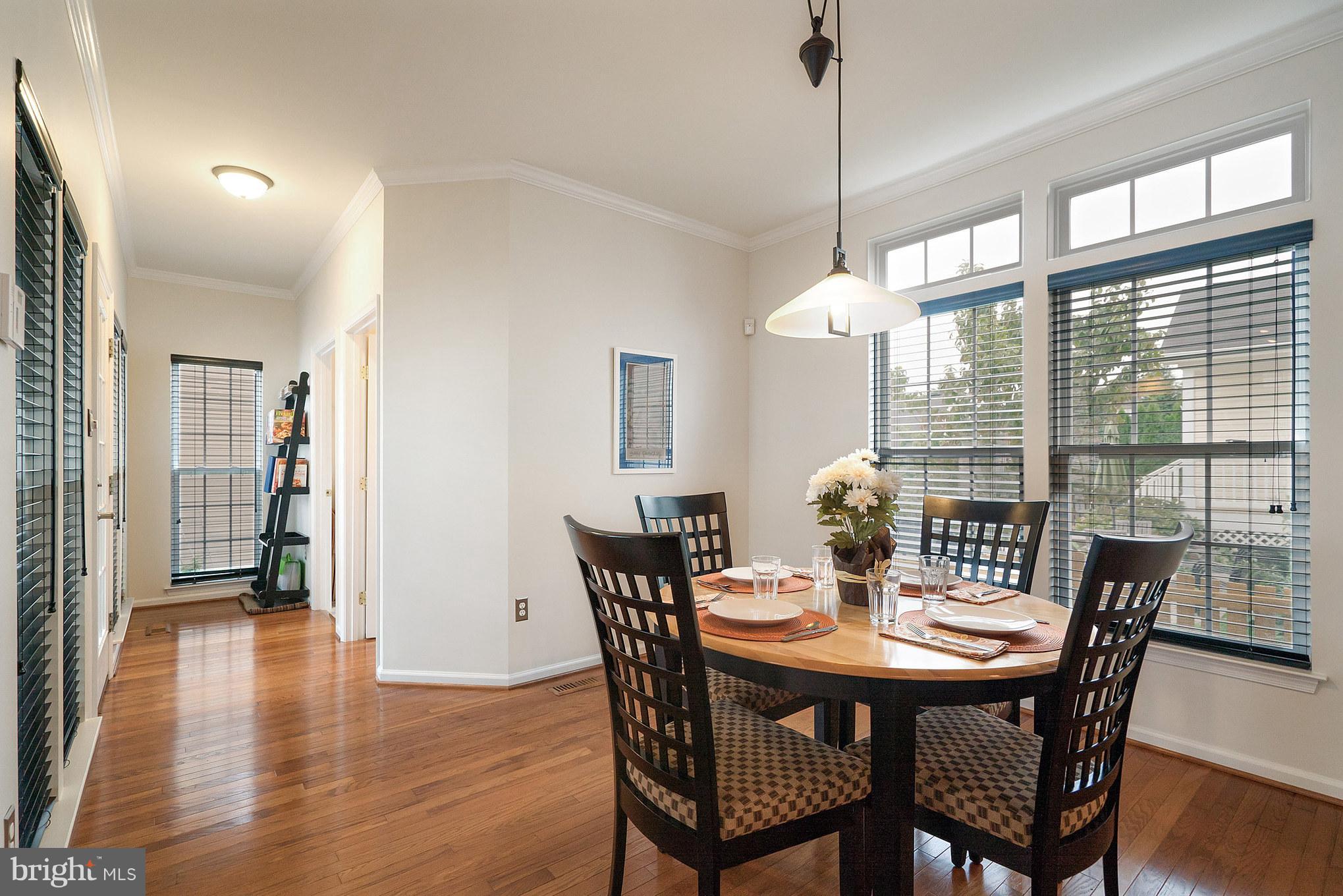 18411 Cornflower Road Boyds, MD 20841 - Photo 12 of 28 a view of a dining room with furniture window and wooden floor