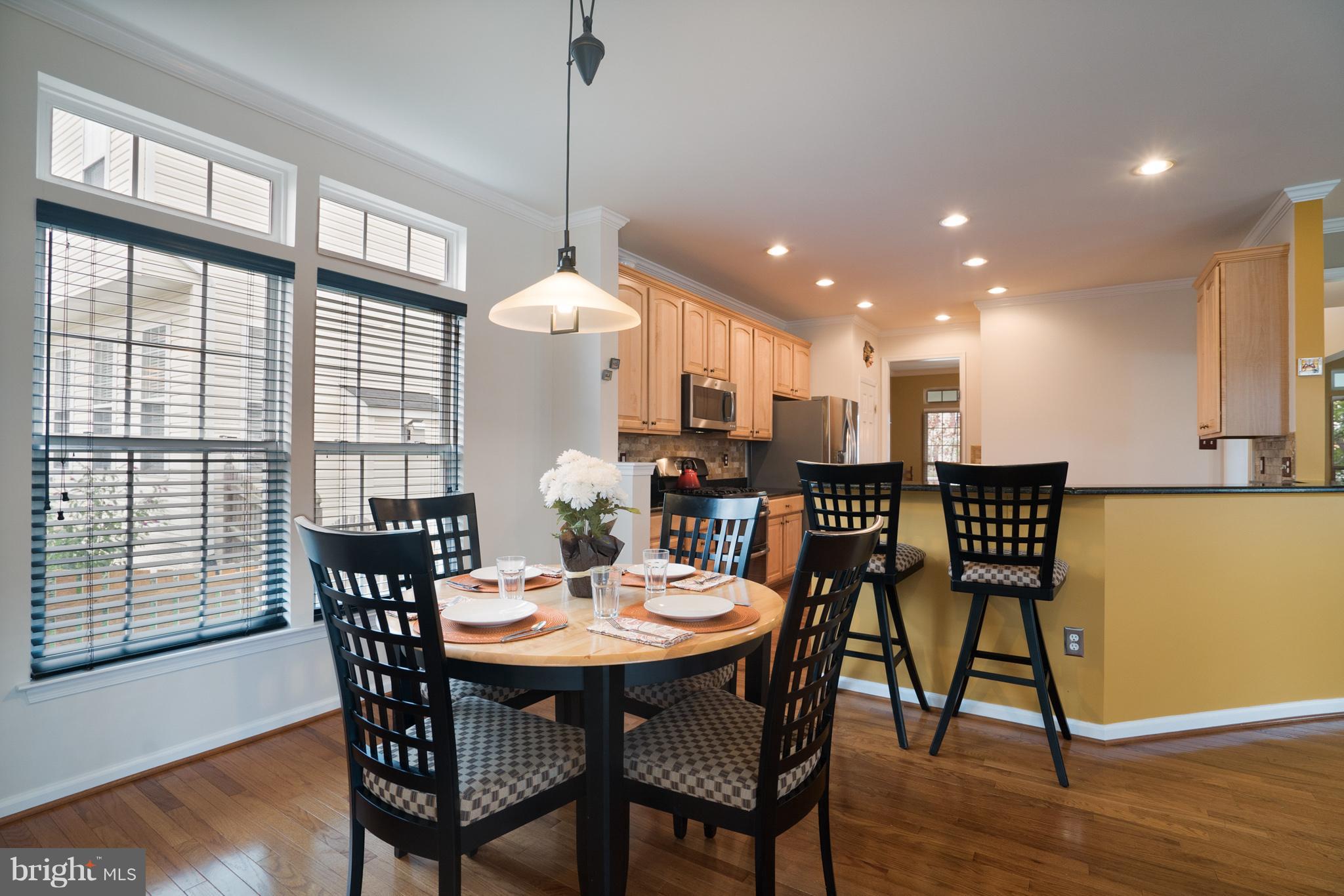 18411 Cornflower Road Boyds, MD 20841 - Photo 13 of 28 a dining room filled with furniture and wooden floor
