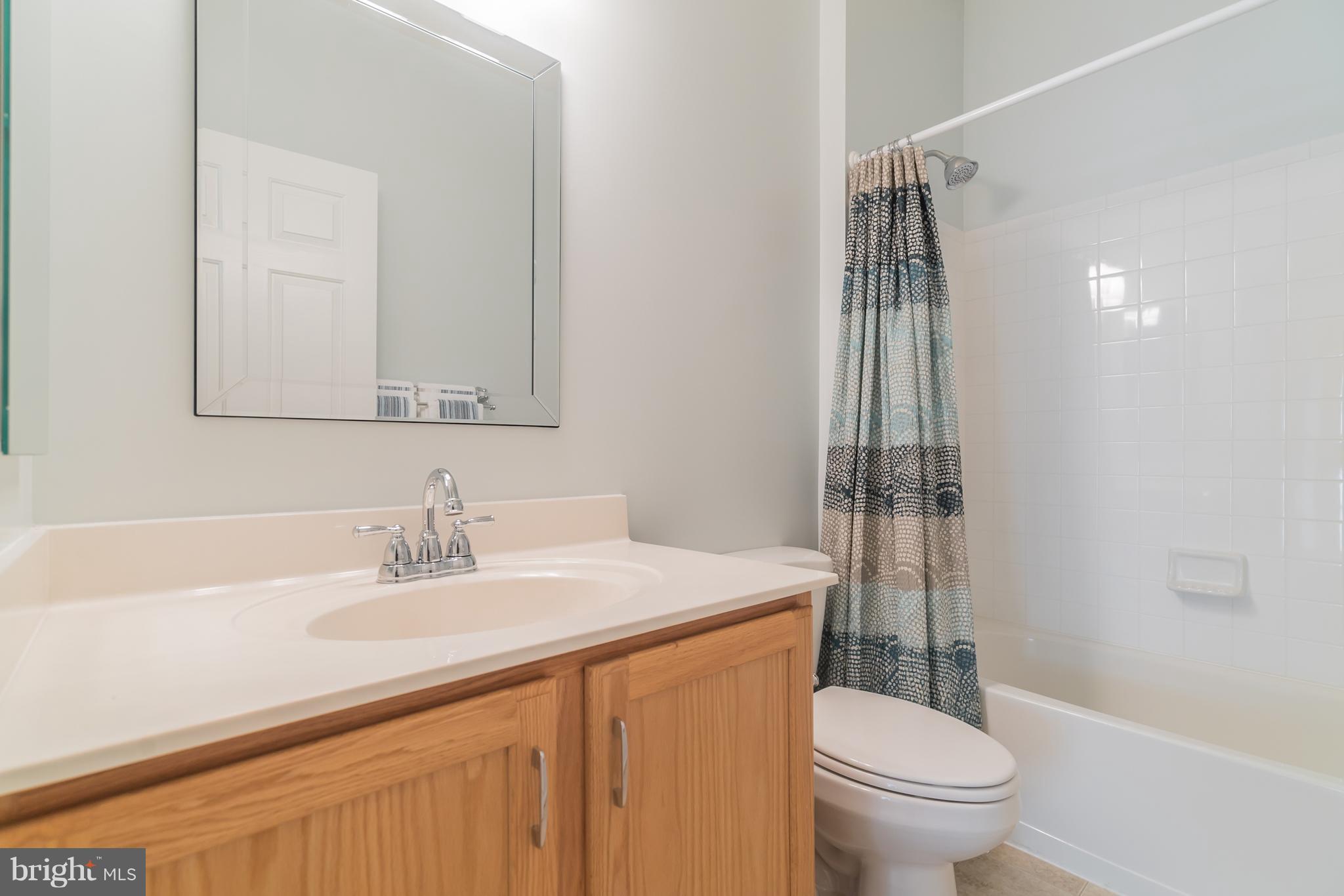 18411 Cornflower Road Boyds, MD 20841 - Photo 24 of 28 a bathroom with a sink toilet vanity and shower