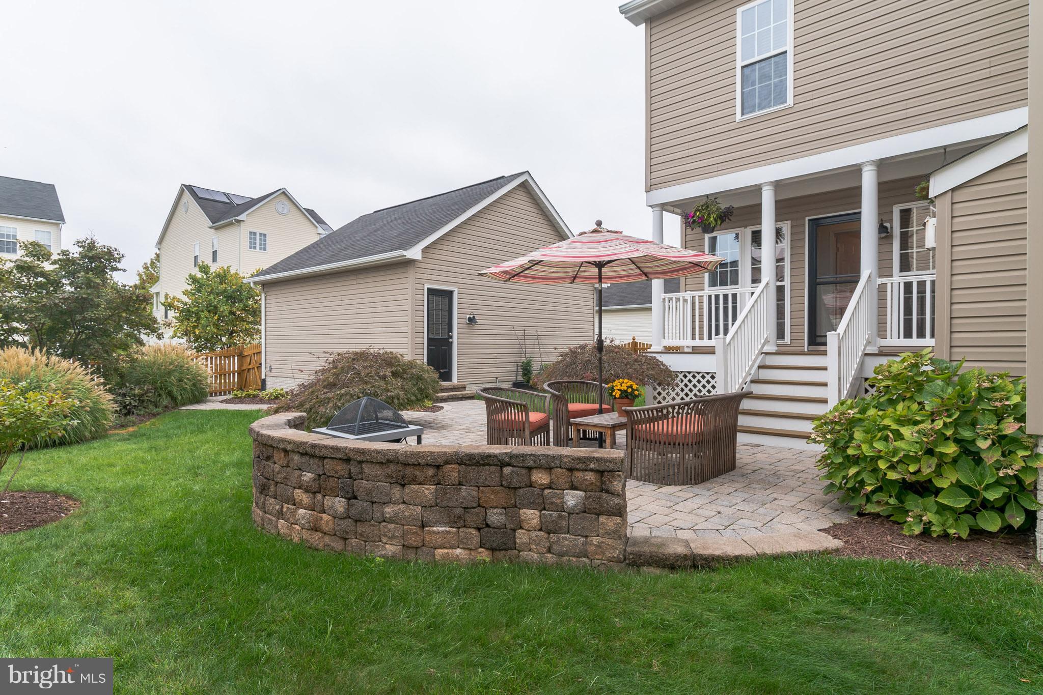 18411 Cornflower Road Boyds, MD 20841 - Photo 26 of 28 a front view of a house with a garden