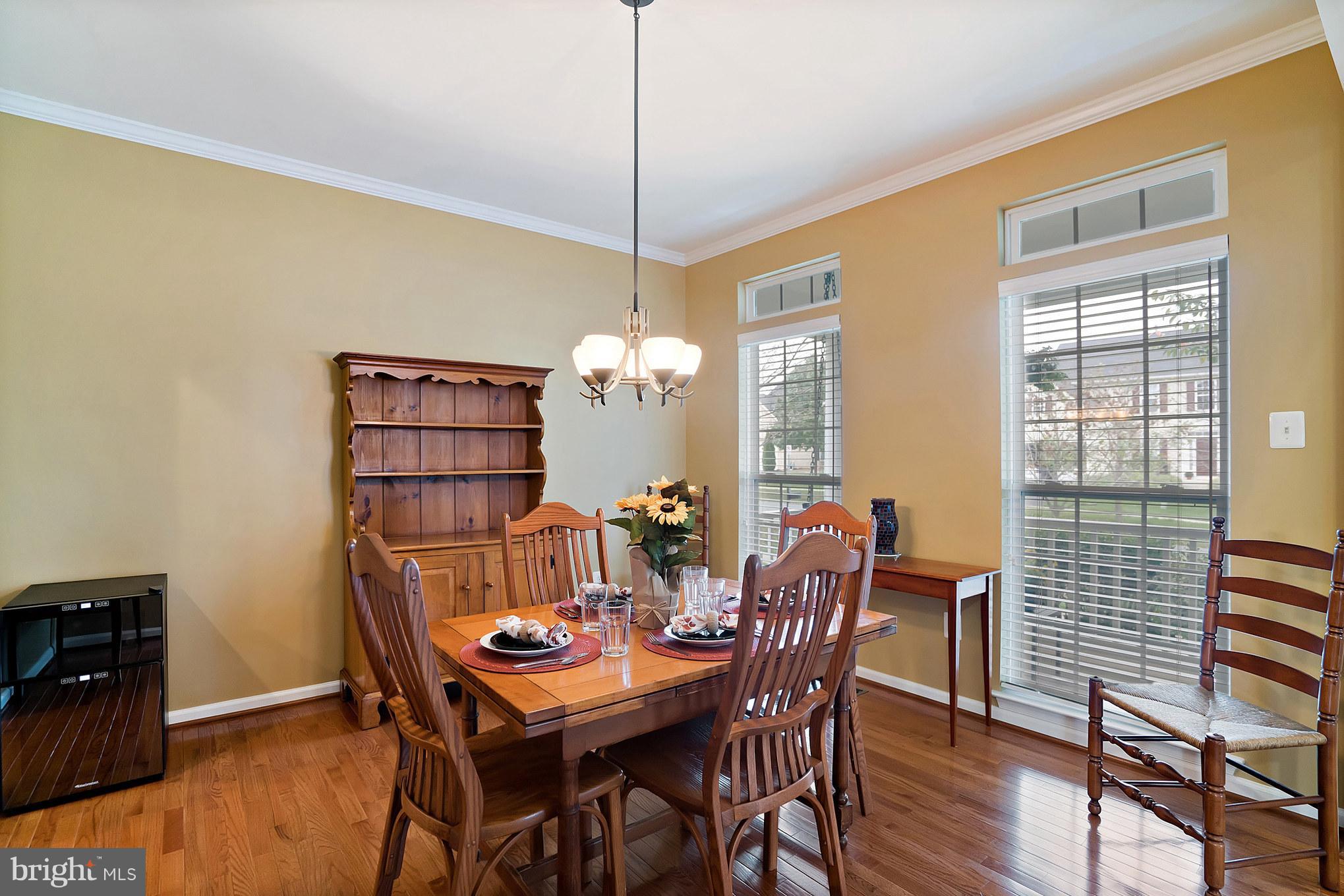 18411 Cornflower Road Boyds, MD 20841 - Photo 7 of 28 a view of a dining room with furniture window and wooden floor