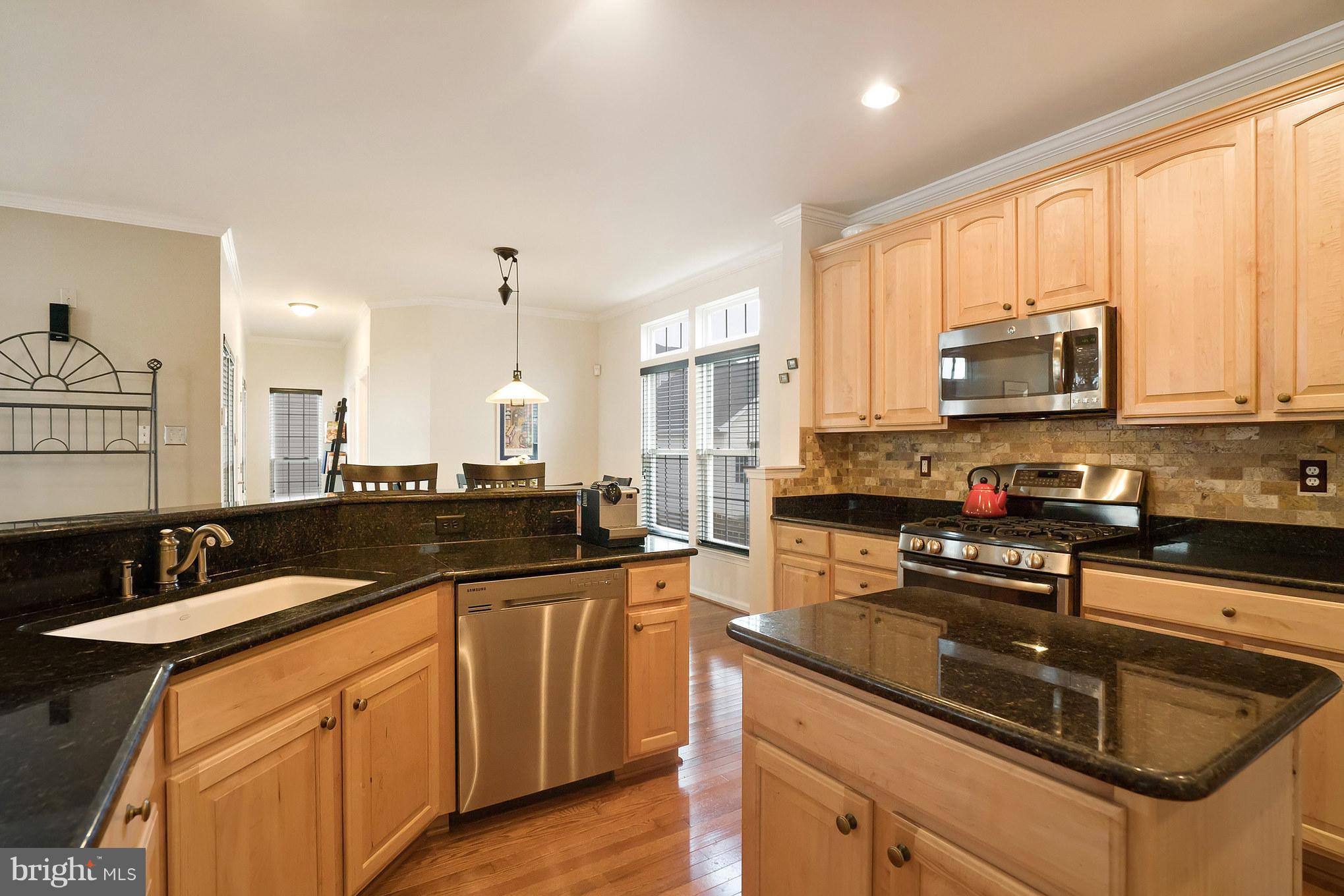 18411 Cornflower Road Boyds, MD 20841 - Photo 10 of 28 a kitchen with stainless steel appliances granite countertop a sink a stove and cabinets