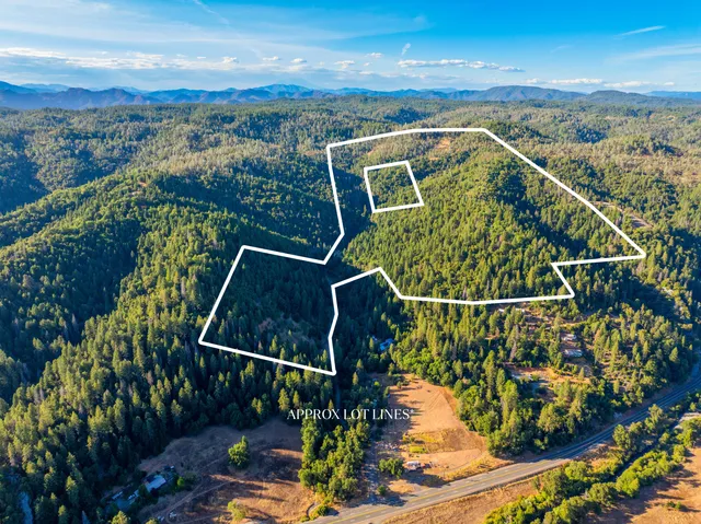 an aerial view of a swimming pool with a yard