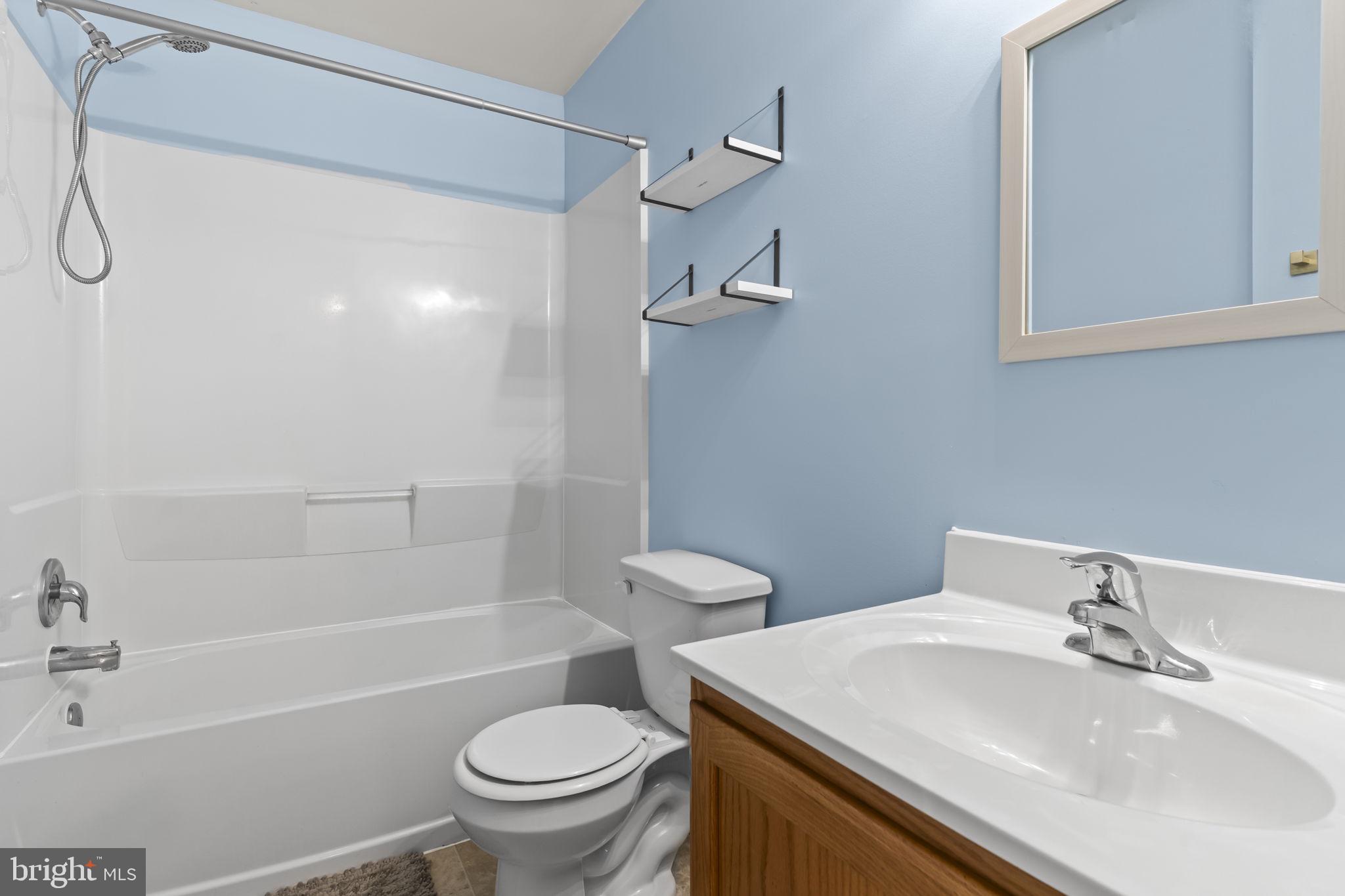 8536 F Street Chesapeake Beach, MD 20732 - Photo 14 of 26 a bathroom with a sink a toilet and shower