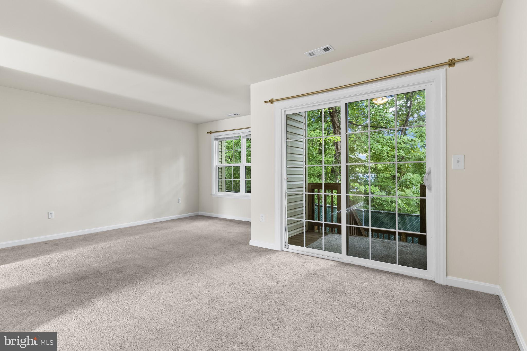 8536 F Street Chesapeake Beach, MD 20732 - Photo 8 of 26 a view of an empty room with a large window