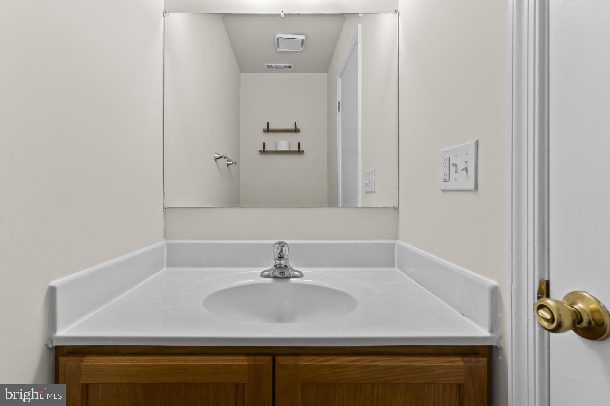8536 F Street Chesapeake Beach, MD 20732 - Photo 10 of 26 a bathroom with a sink and vanity