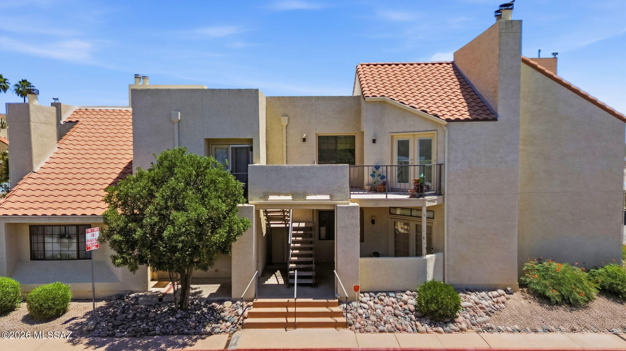 1200 East River Road, Unit G87 Tucson, AZ 85718 - Photo 1 of 30 a front view of a house with garden