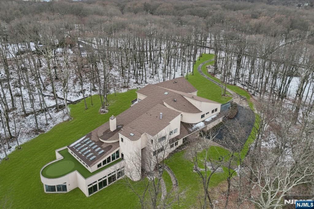 an aerial view of a house with garden space and street view