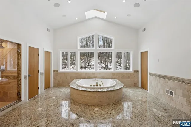 a view of a bathroom with a tub and shower