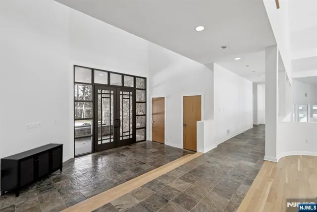 wooden floor with windows and chandelier in a room