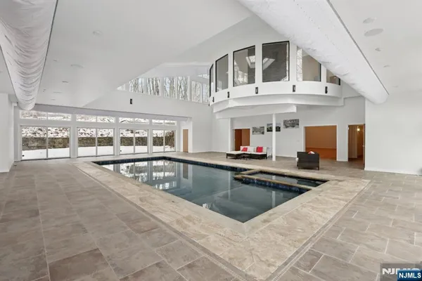 a view of a swimming pool with outdoor seating