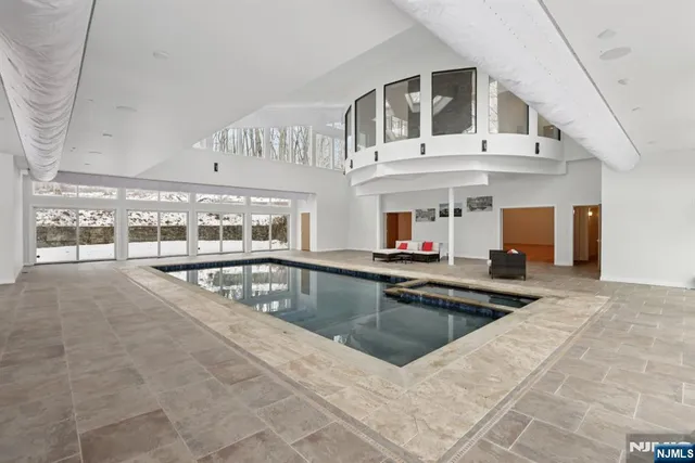 a view of a swimming pool with outdoor seating