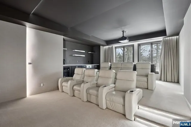 a living room with furniture a ceiling fan and a rug