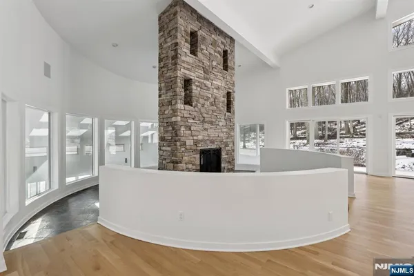 a living room with furniture a large window and wooden floor