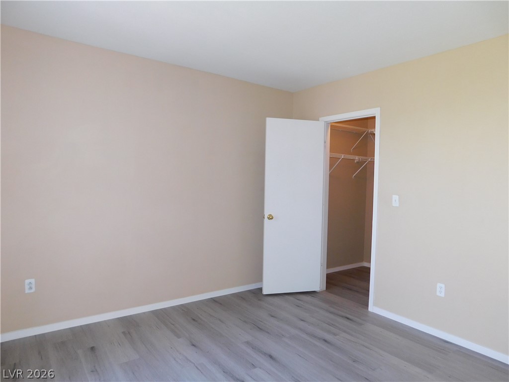 7255 West Sunset Road, Unit 2029 Las Vegas, NV 89113 - Photo 16 of 21 A spacious bedroom with contemporary flooring and a walk-in closet, ready for personalized touches.