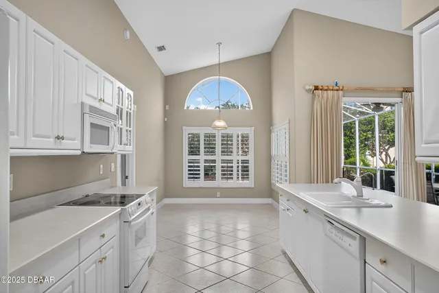 a kitchen with a sink and a large window